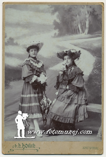 Dve devojčice sa šeširima i suncobranima (autor Ljubiša Đonić)